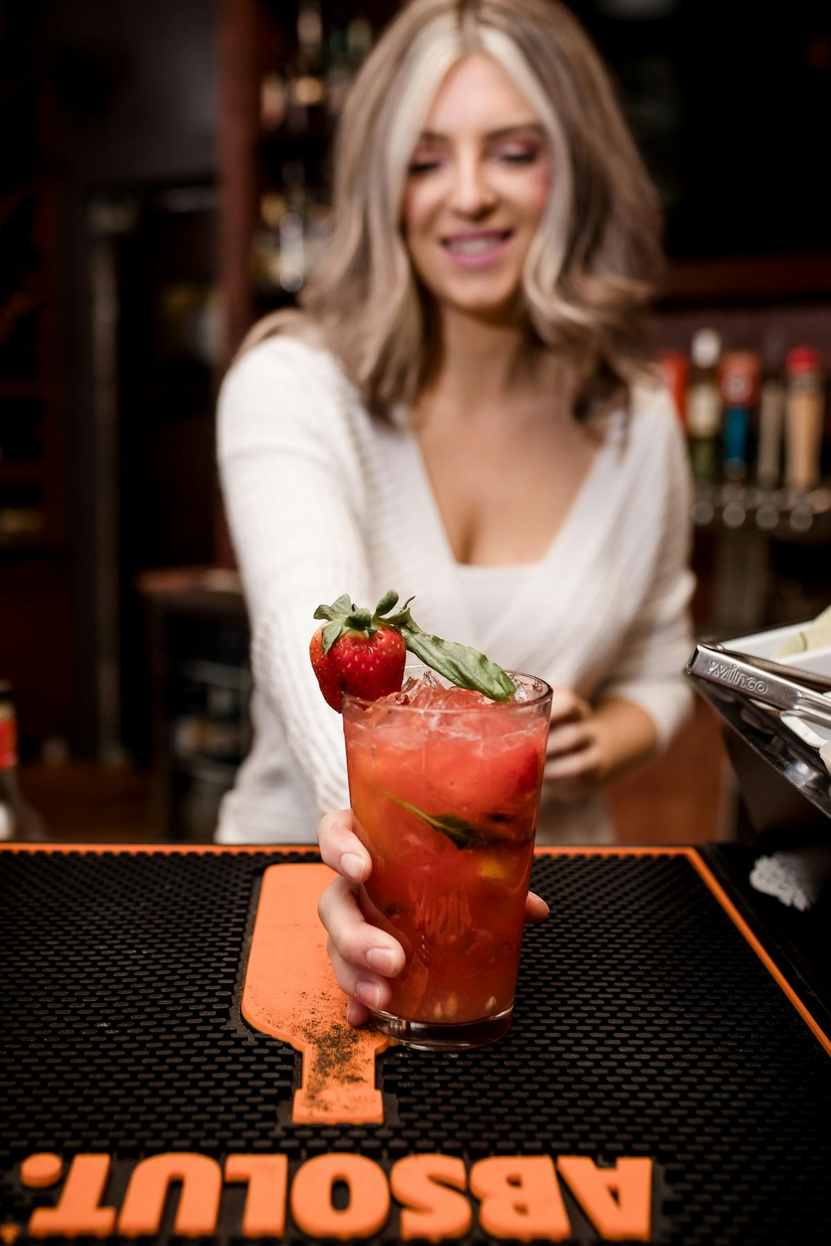 a woman serving a cocktail