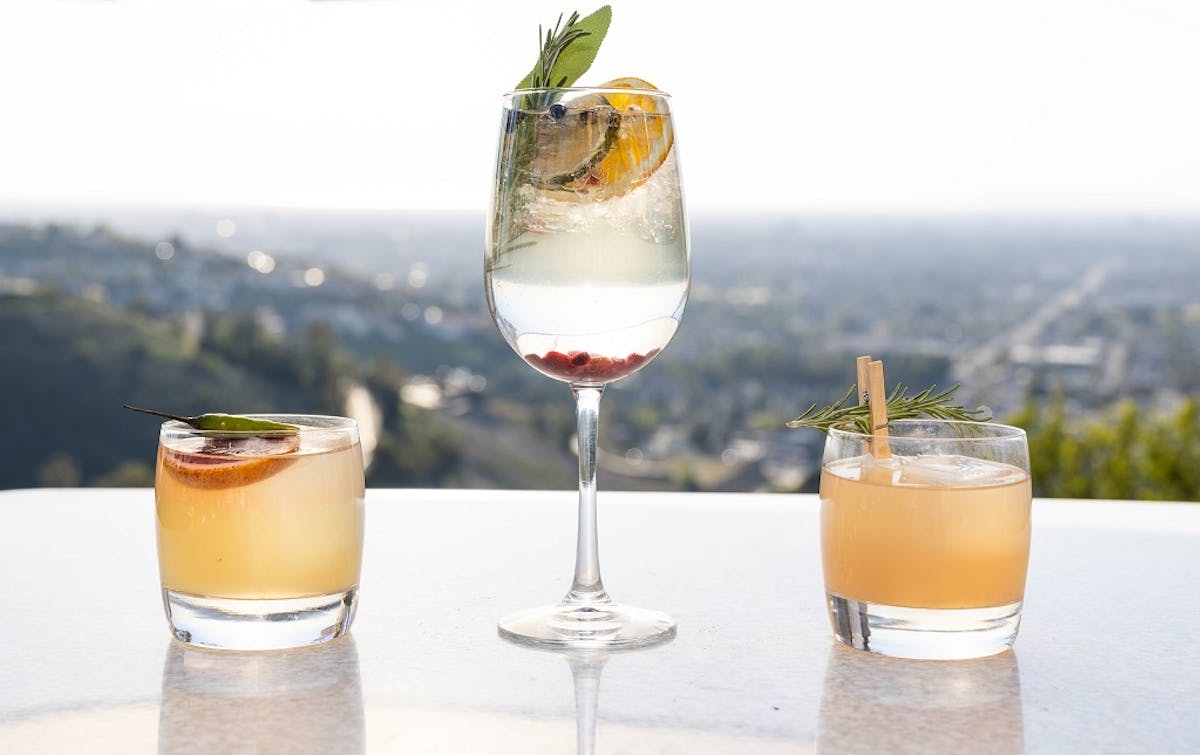 three cocktails with view in background