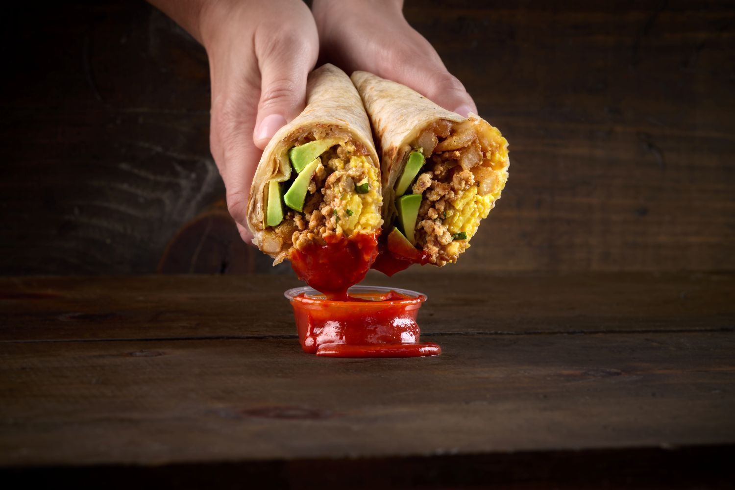 The Tighty Whitey Breakfast Burrito with Smoked Maple Chipotle Chicken Chorizo, Eggs, Fries, Bacon, Alabama White Queso, Avocado, Sweet Chili Sauce found on Taco Bamba's breakfast menu