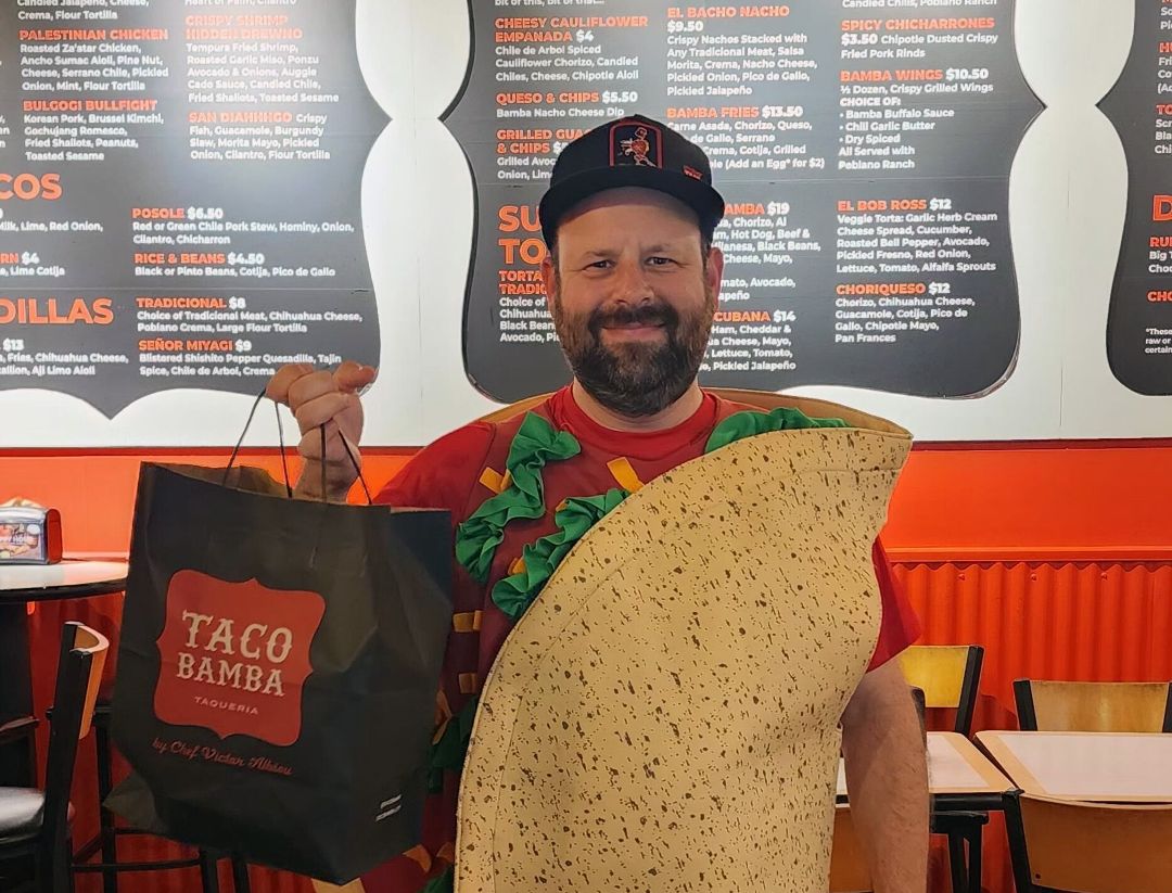 Man dressed as a taco inside a Taco Bamba