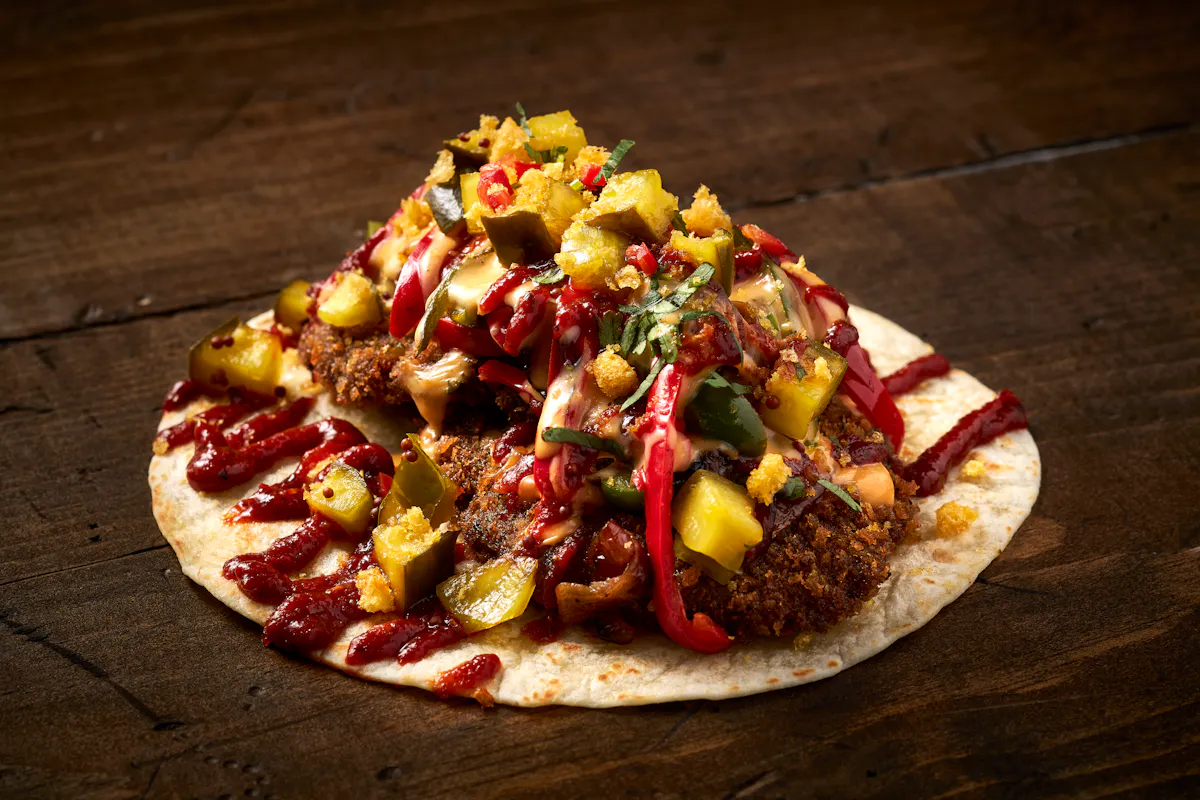 a pizza sitting on top of a wooden cutting board