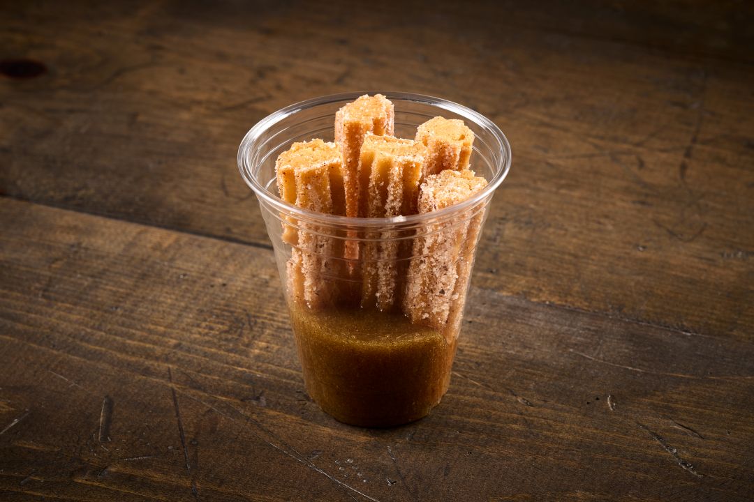 Caramelized Pineapple Churros with Crispy Cinnamon-Dusted Churros Dipped in Caramelized Pineapple Sauce found on the dessert menu at Taco Bamba