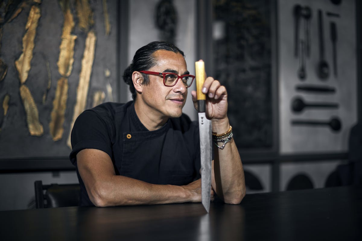Chef Carlos Gaytán holding a knife