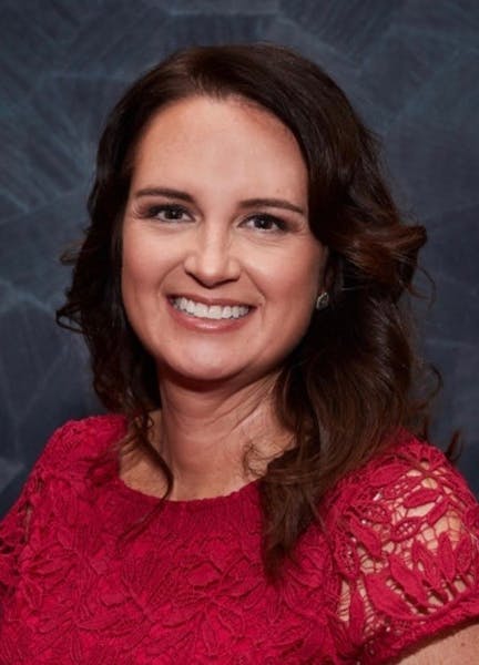 a close up of a woman in a red shirt