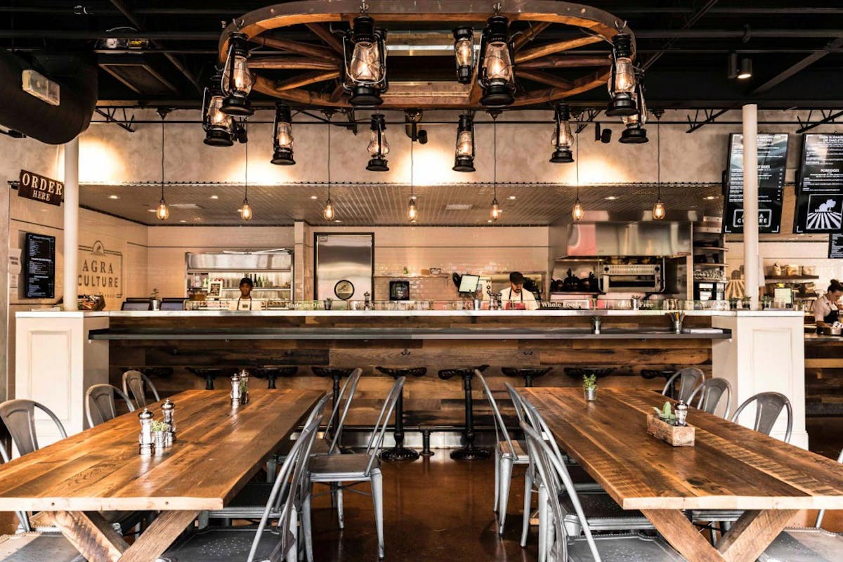 a kitchen with wooden cabinets and a table in a restaurant