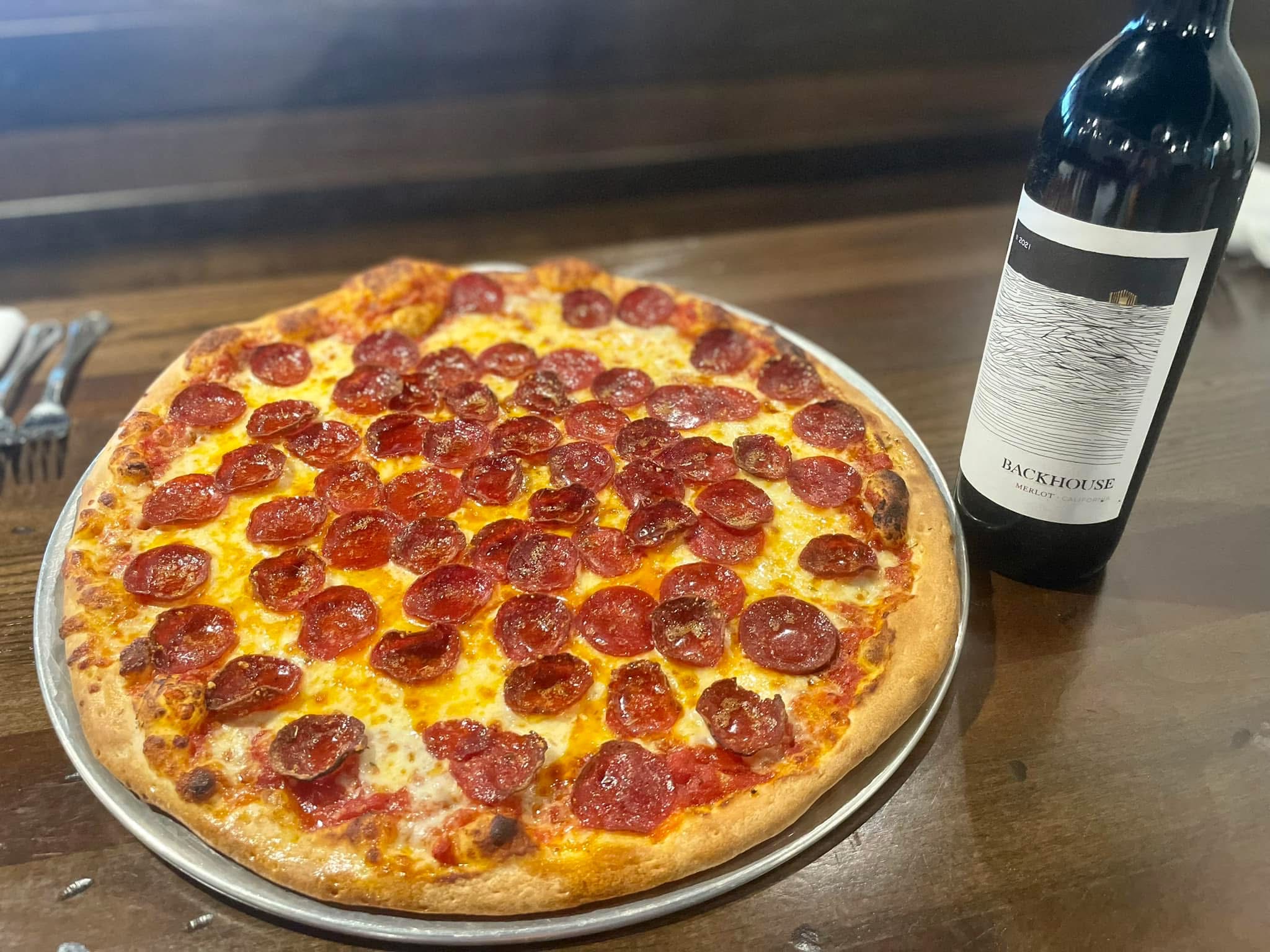 a pepperoni pizza sitting on top of a table