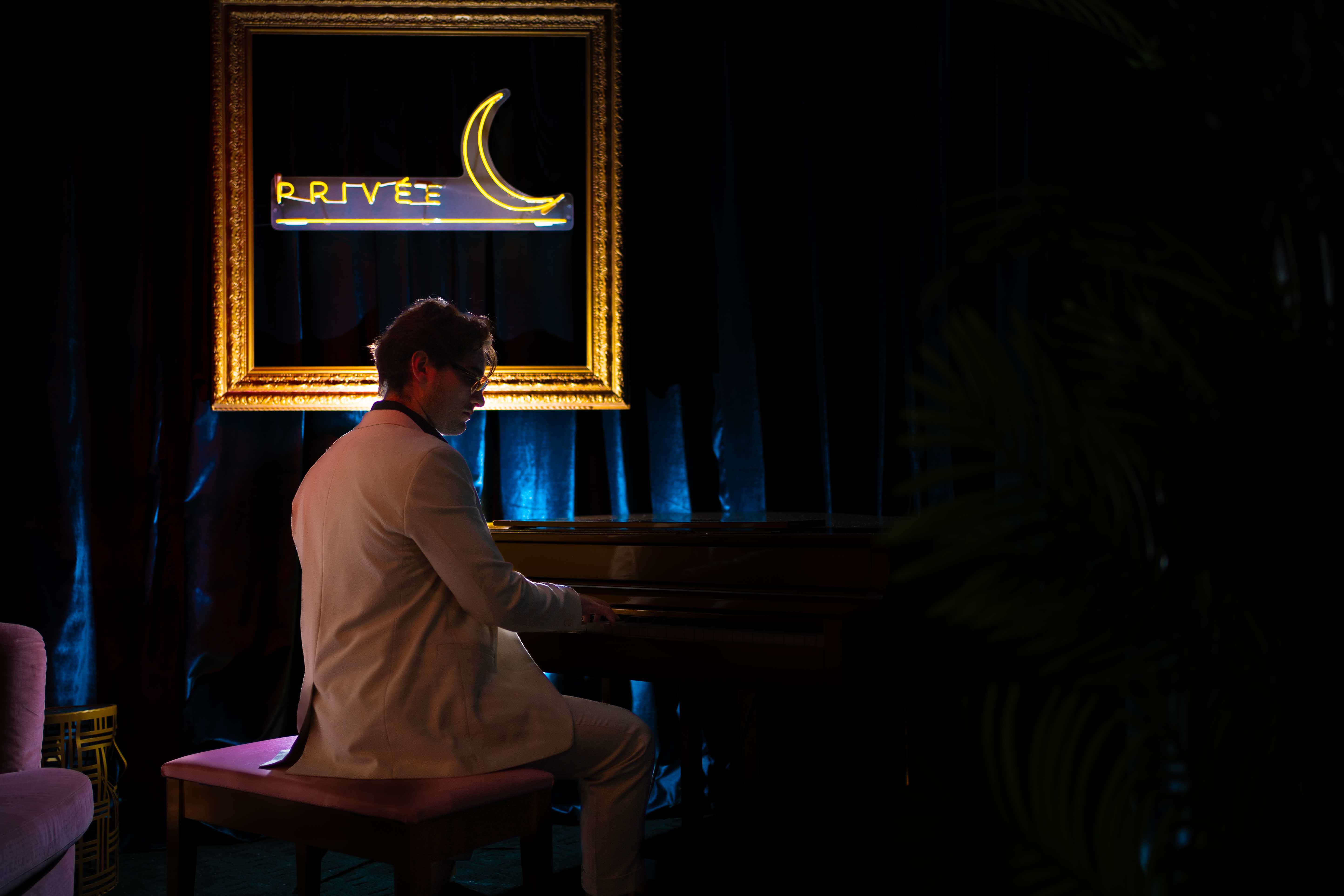 a man standing in front of a piano