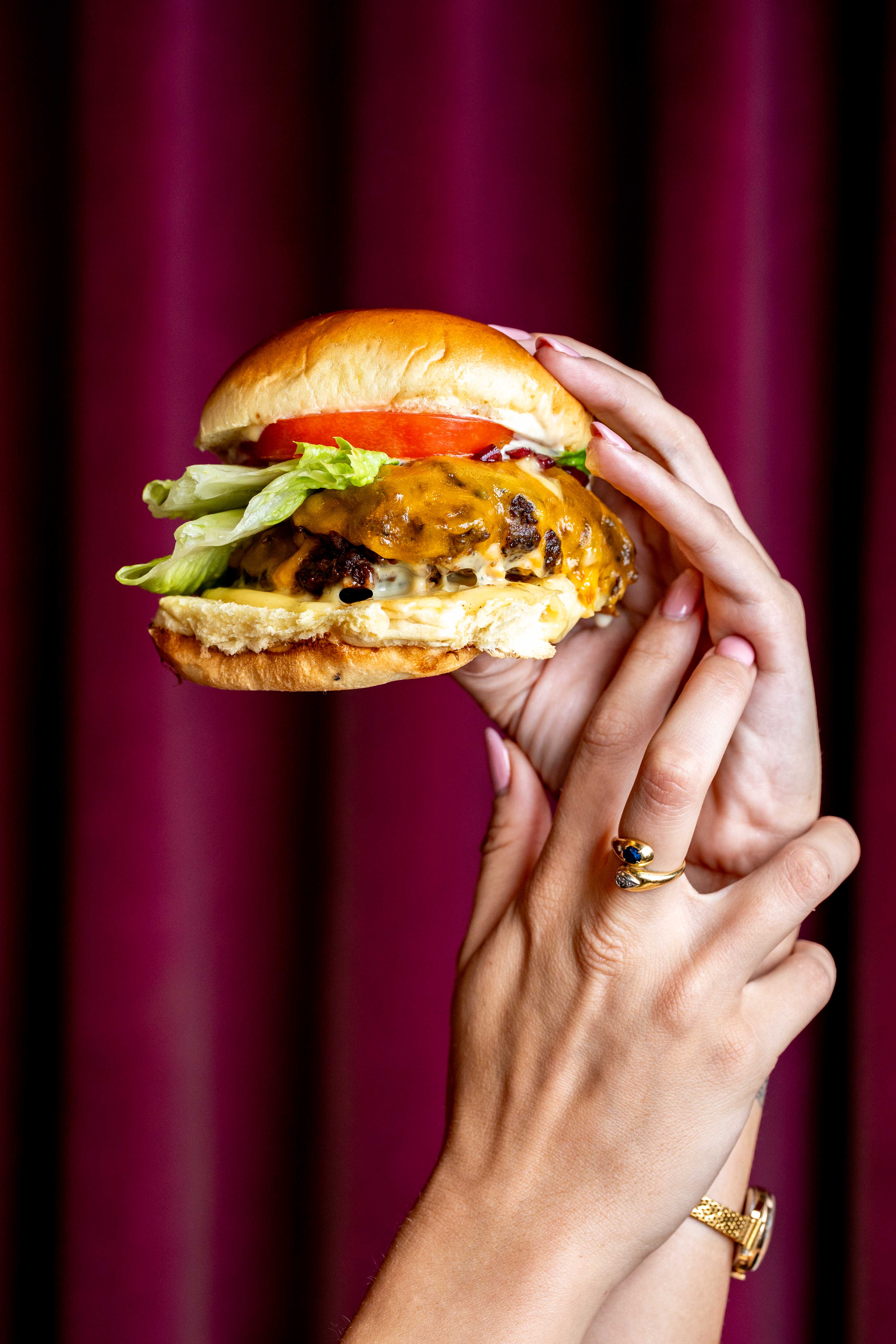 a close up of a person holding a sandwich in his hand