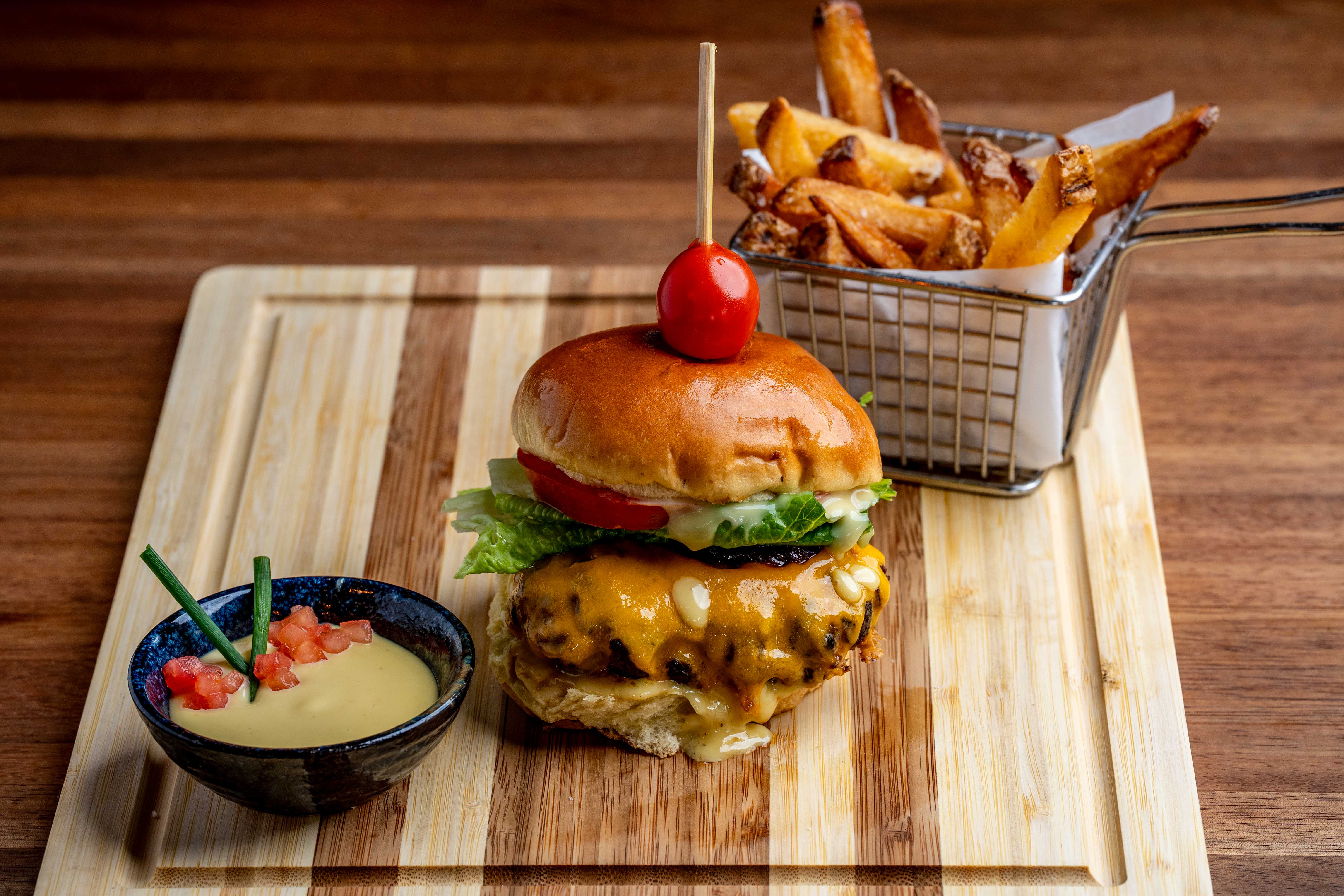a plate of food sitting on top of a wooden cutting board
