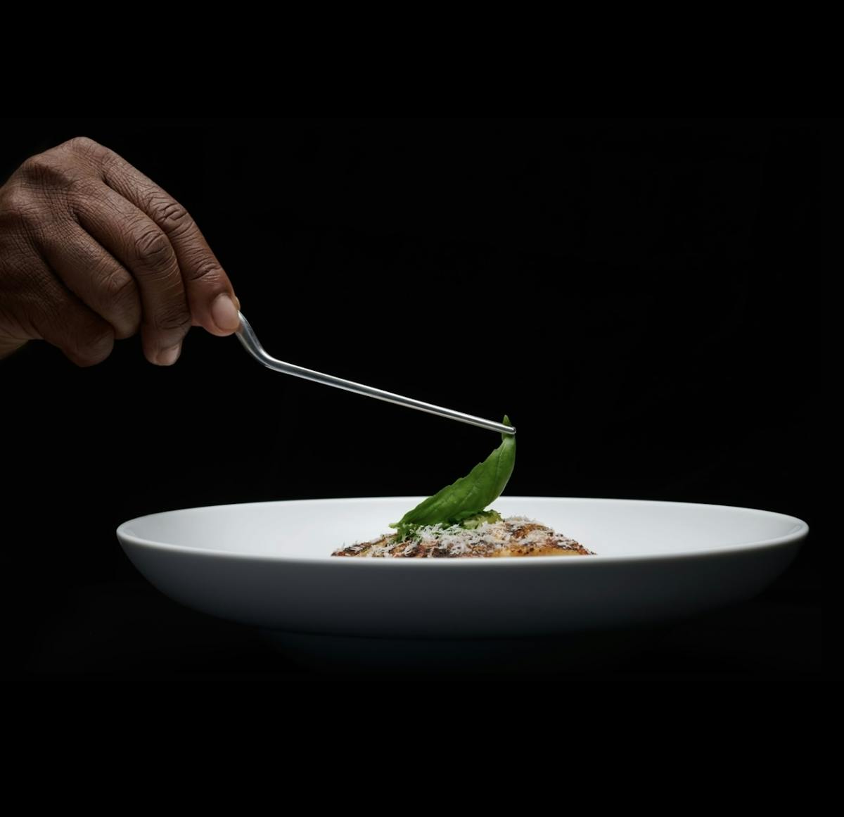 a person sitting at a table with a plate of food