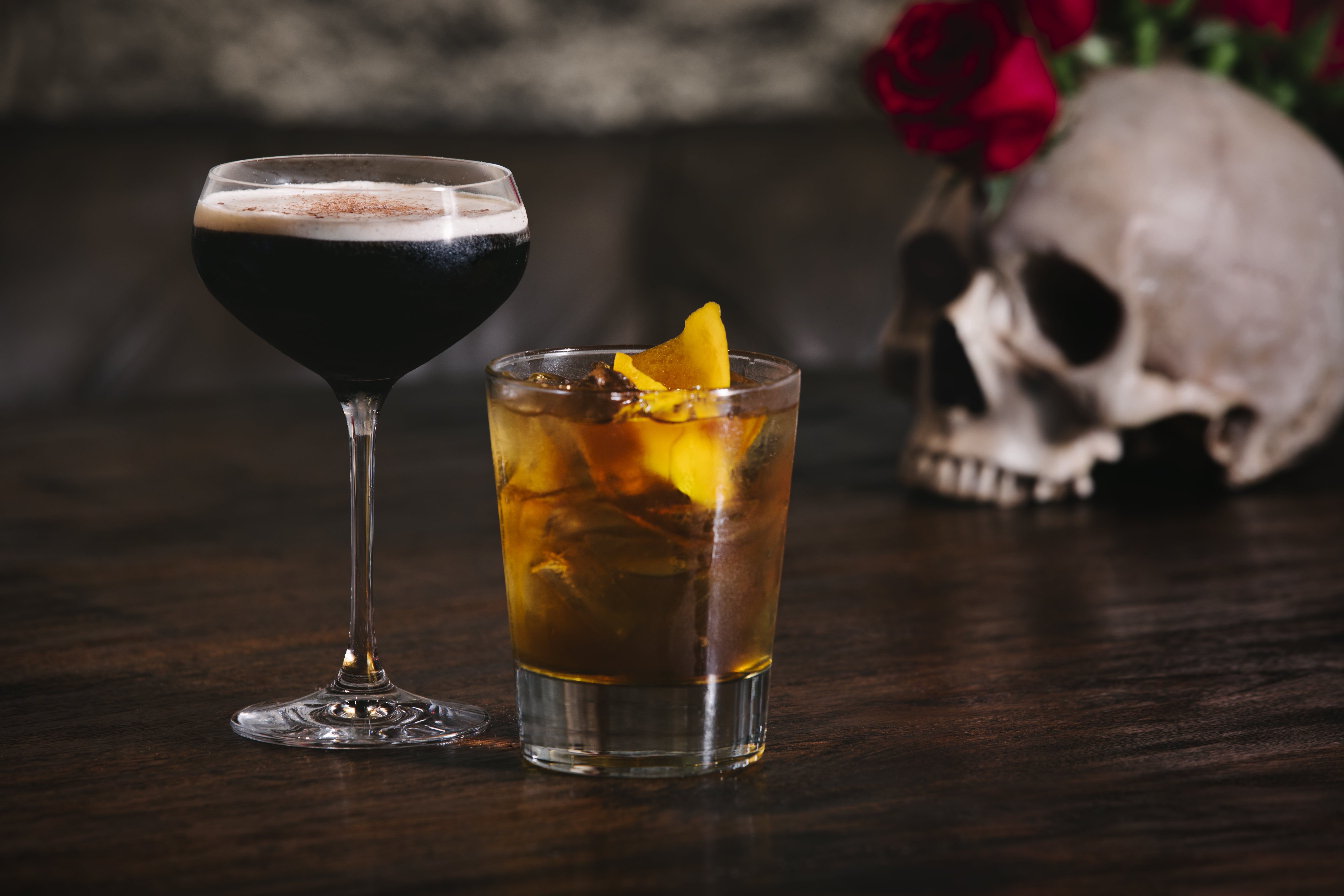 a glass of wine sitting on top of a wooden table