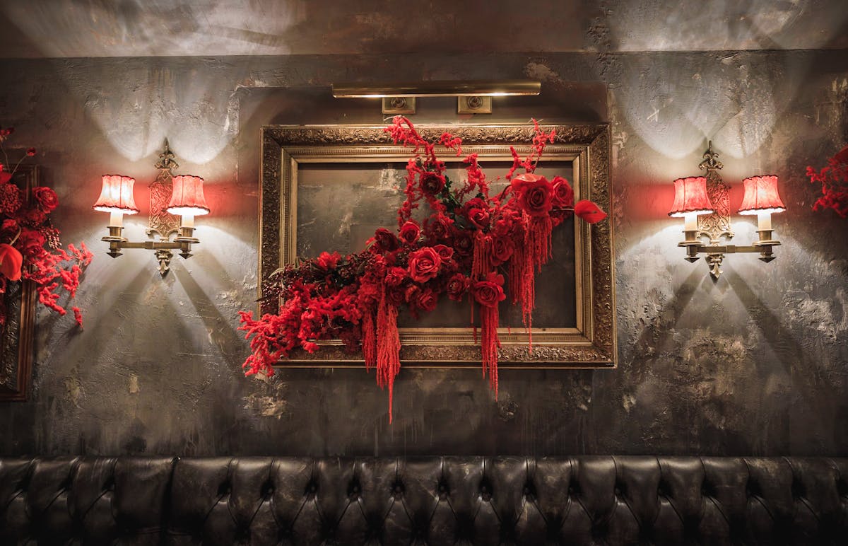 a vase of flowers on a table next to a fireplace