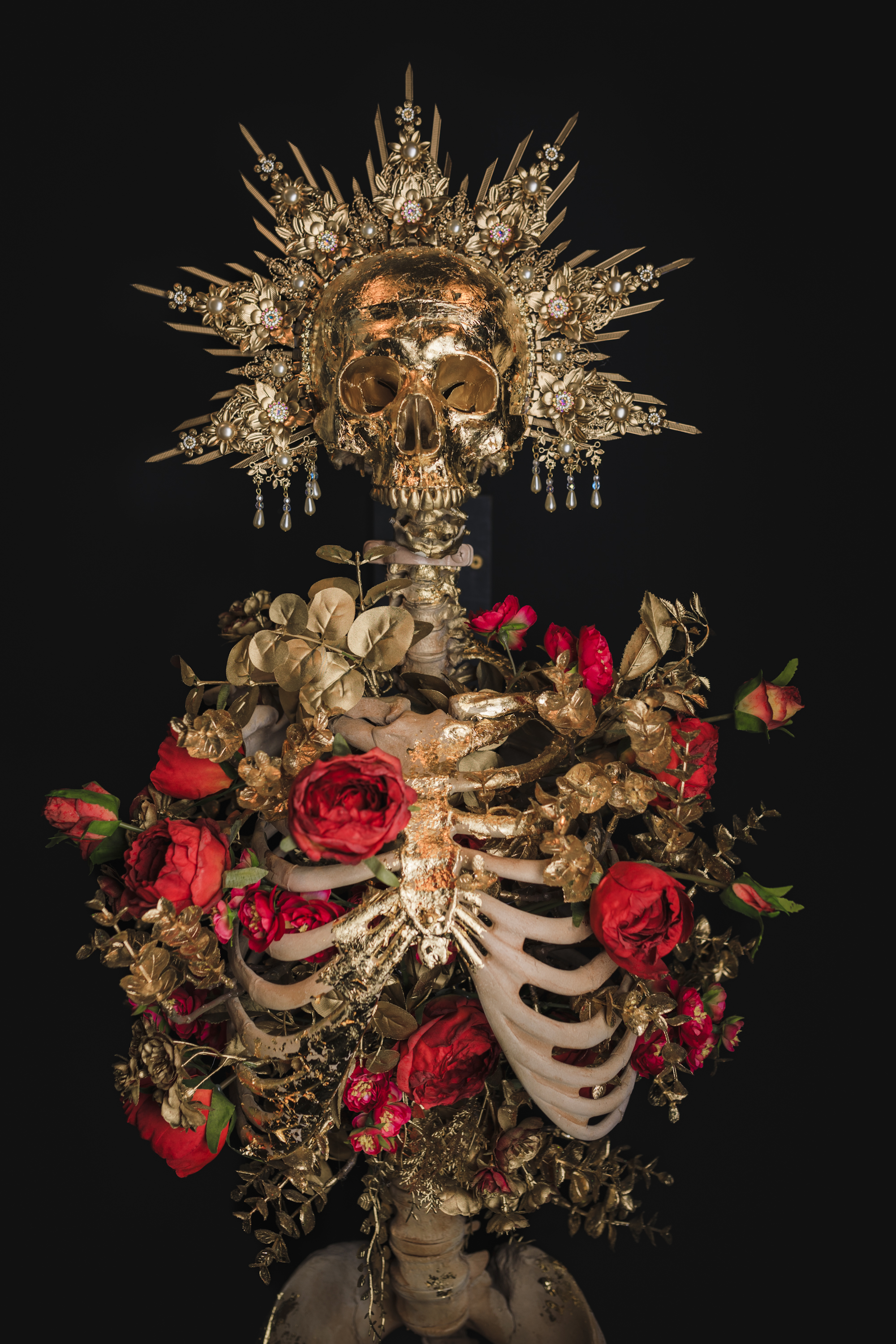 a vase of flowers next to a christmas tree