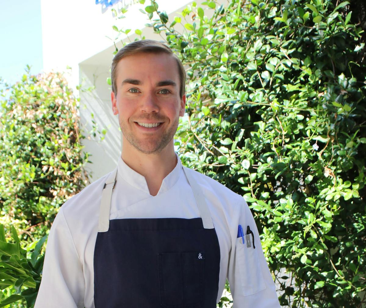 a man standing in front of a forest