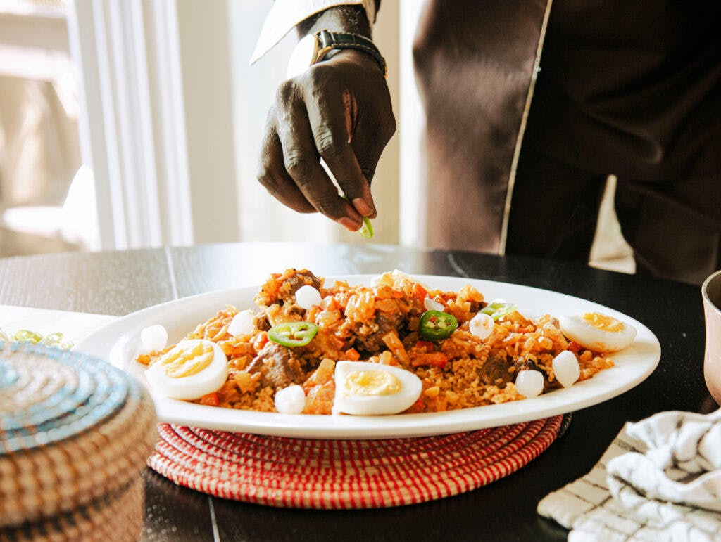 a person sitting at a table with a plate of food