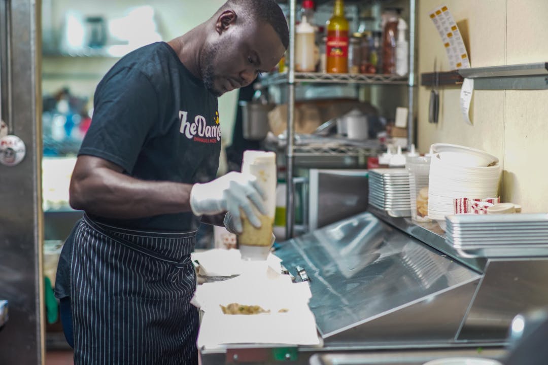 a man standing in a kitchen preparing food
