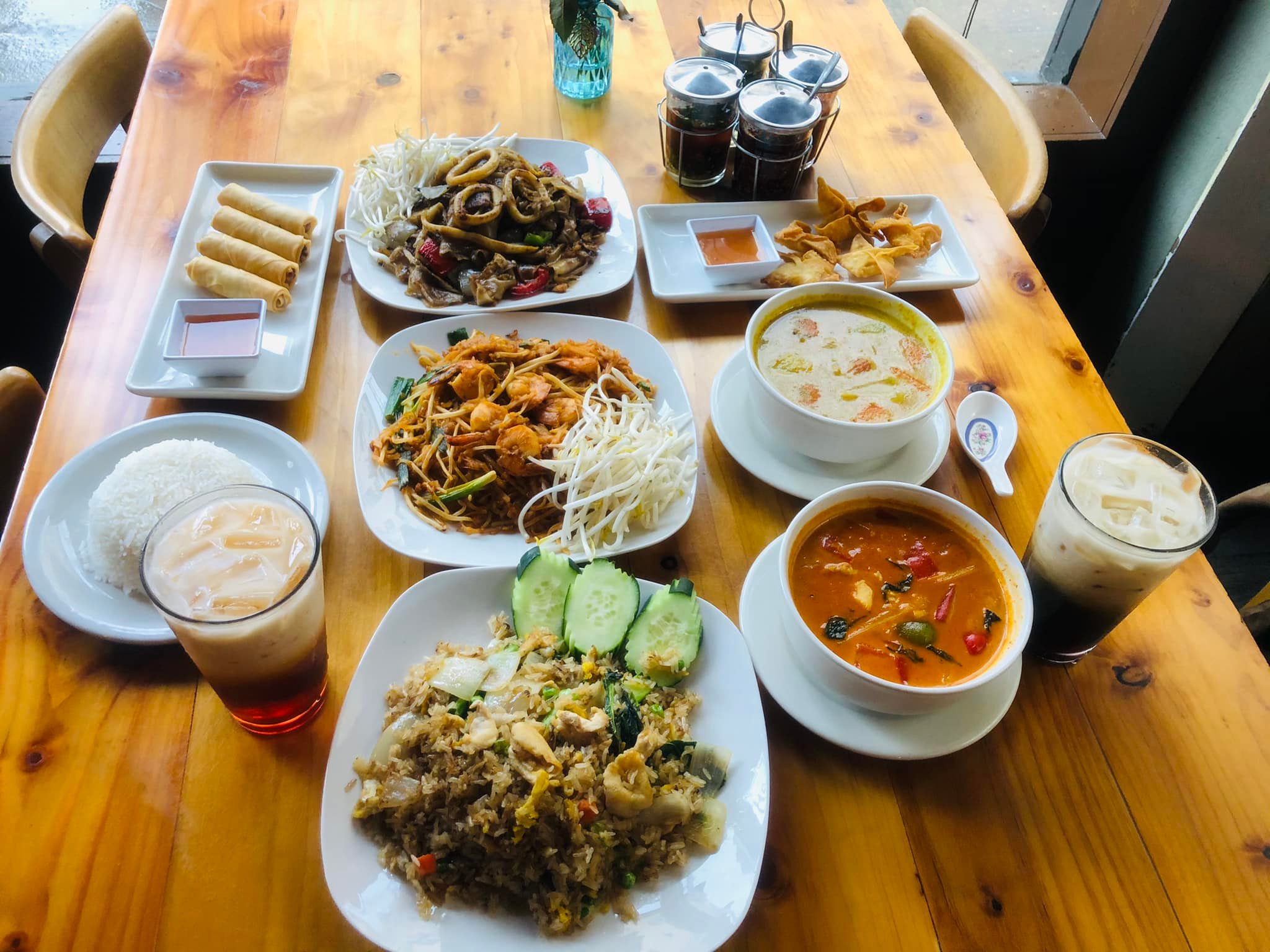 a wooden table topped with plates of food on a plate