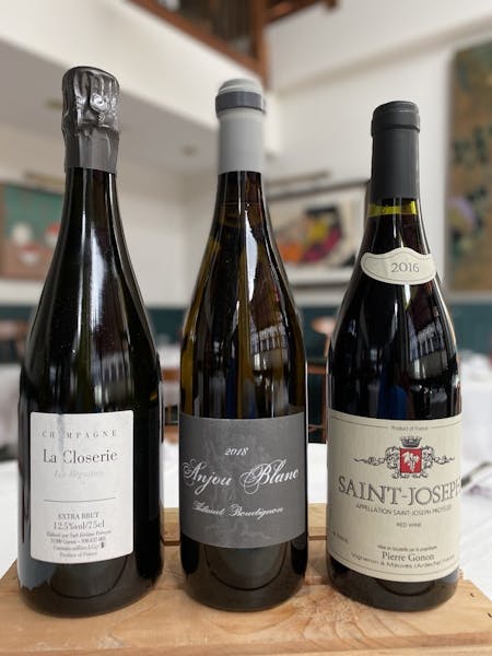 Three bottles of wine on a table