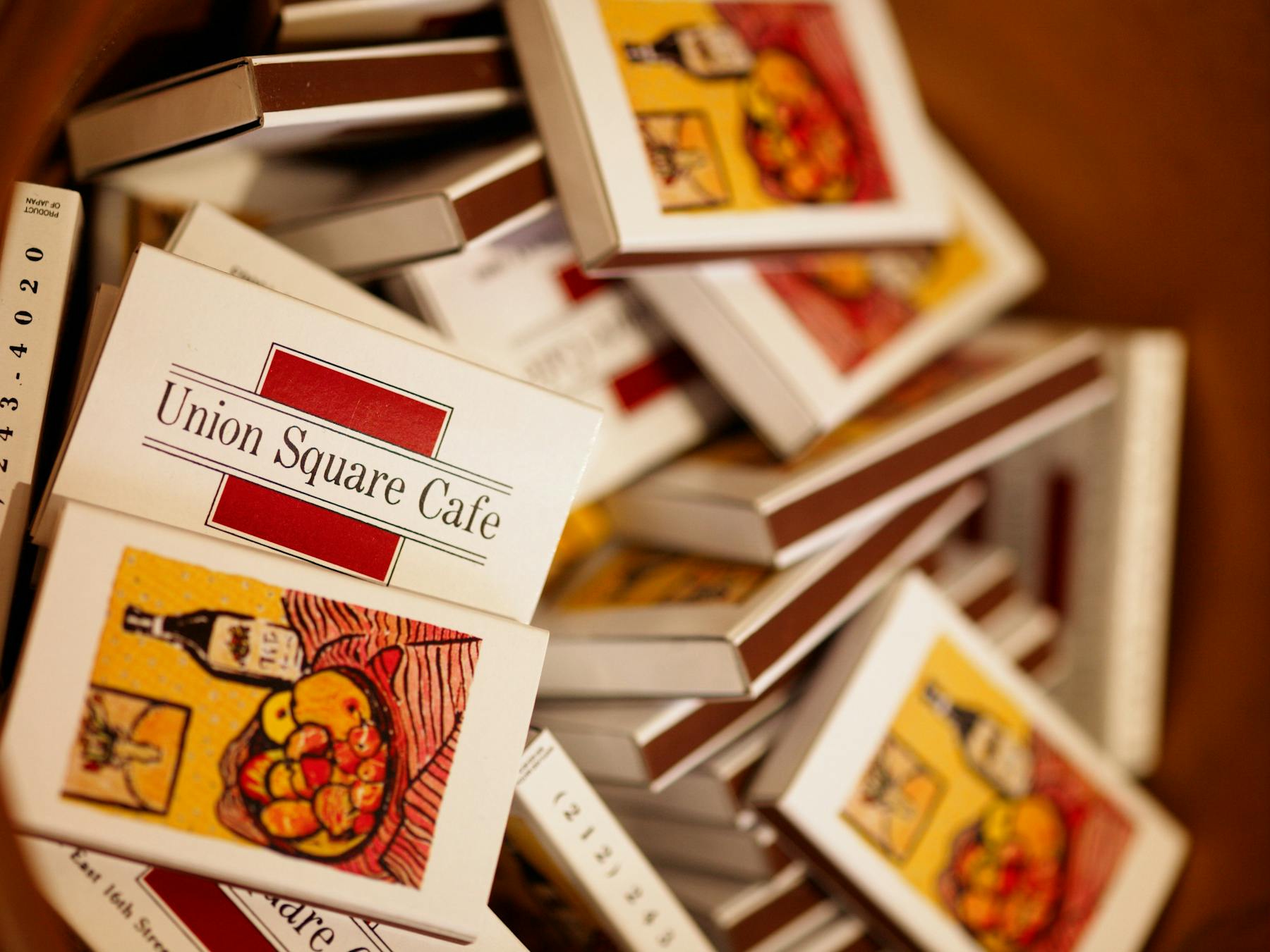 a stack of Union Square Cafe matchbooks