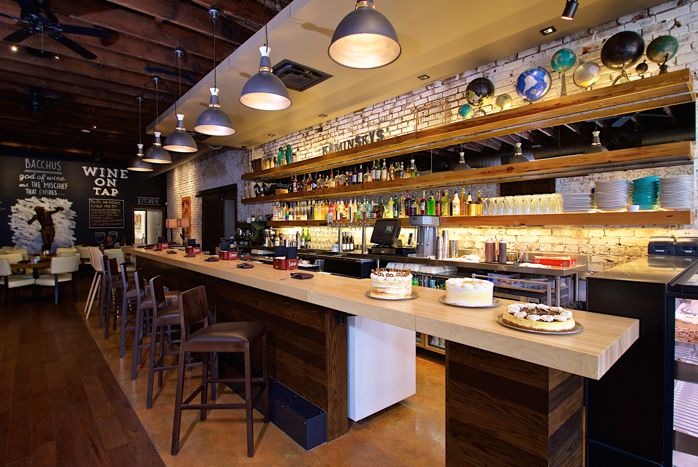 a bar with a counter and shelves with drinks