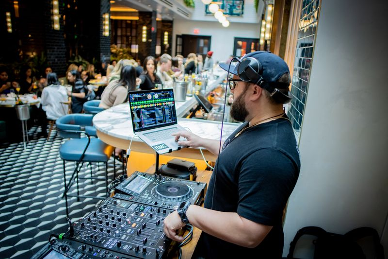 a man standing in front of a laptop
