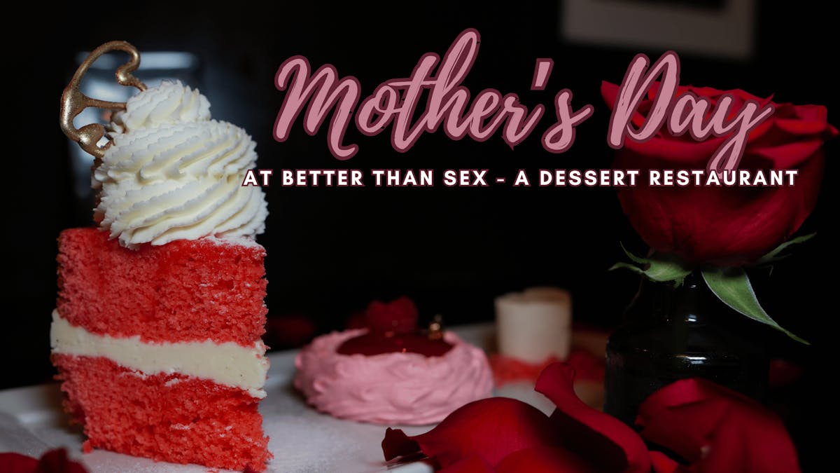 Romantic presentation of a slice of pink cake with whipped cream surrounded by rose petals at Better Than Sex - A Dessert Restaurant
