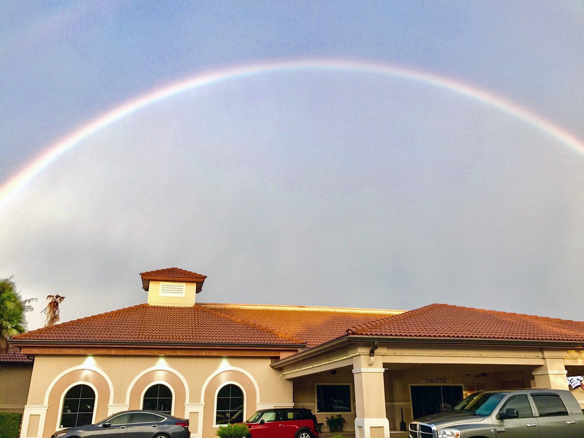 a building with a rainbow in the background