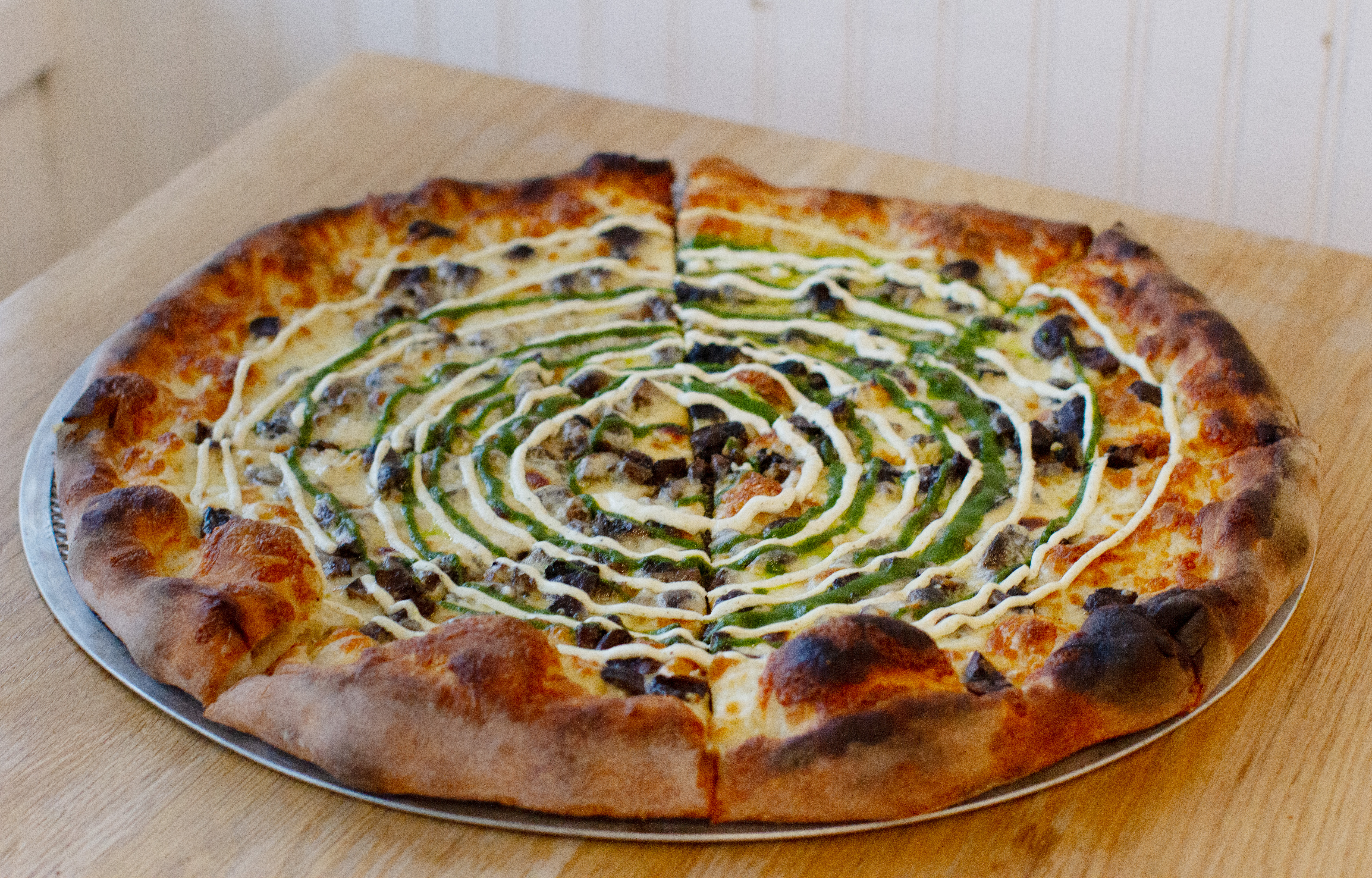 a pizza sitting on top of a wooden table
