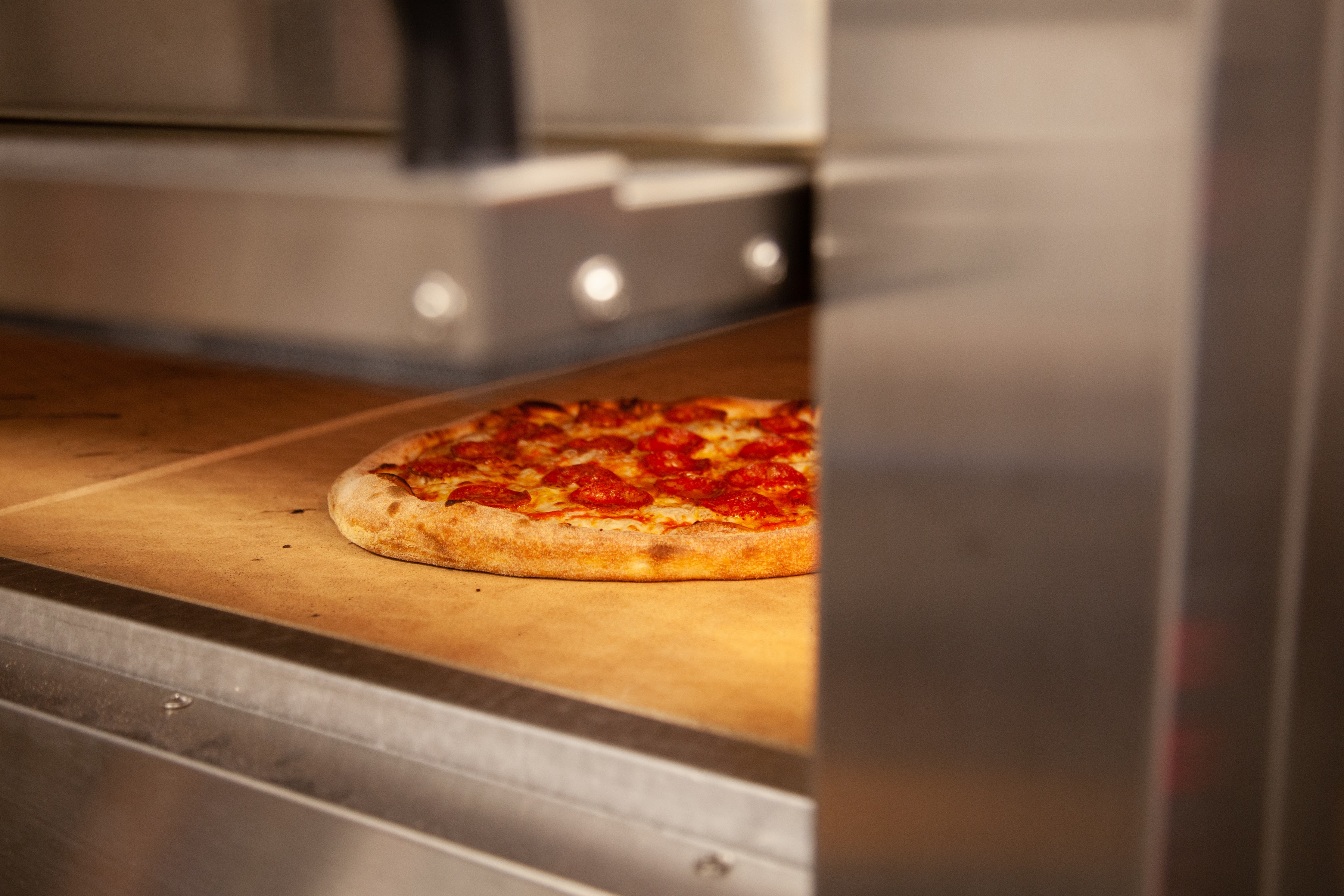 a pizza sitting on top of a stove