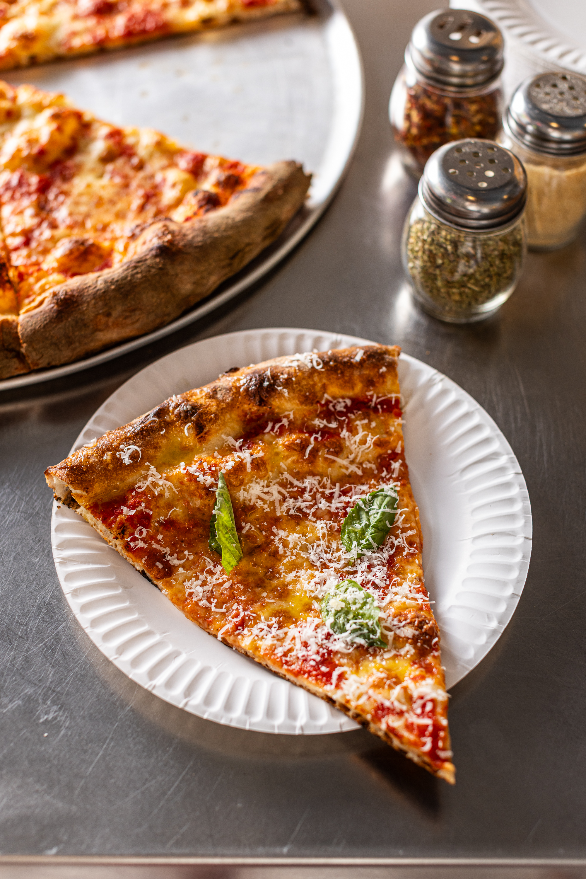 a slice of pizza sitting on top of a table