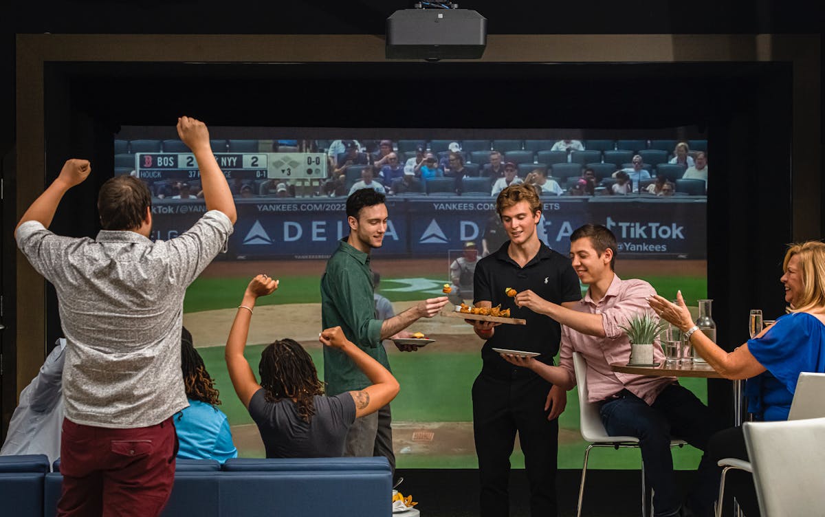 a group of people standing in front of a television