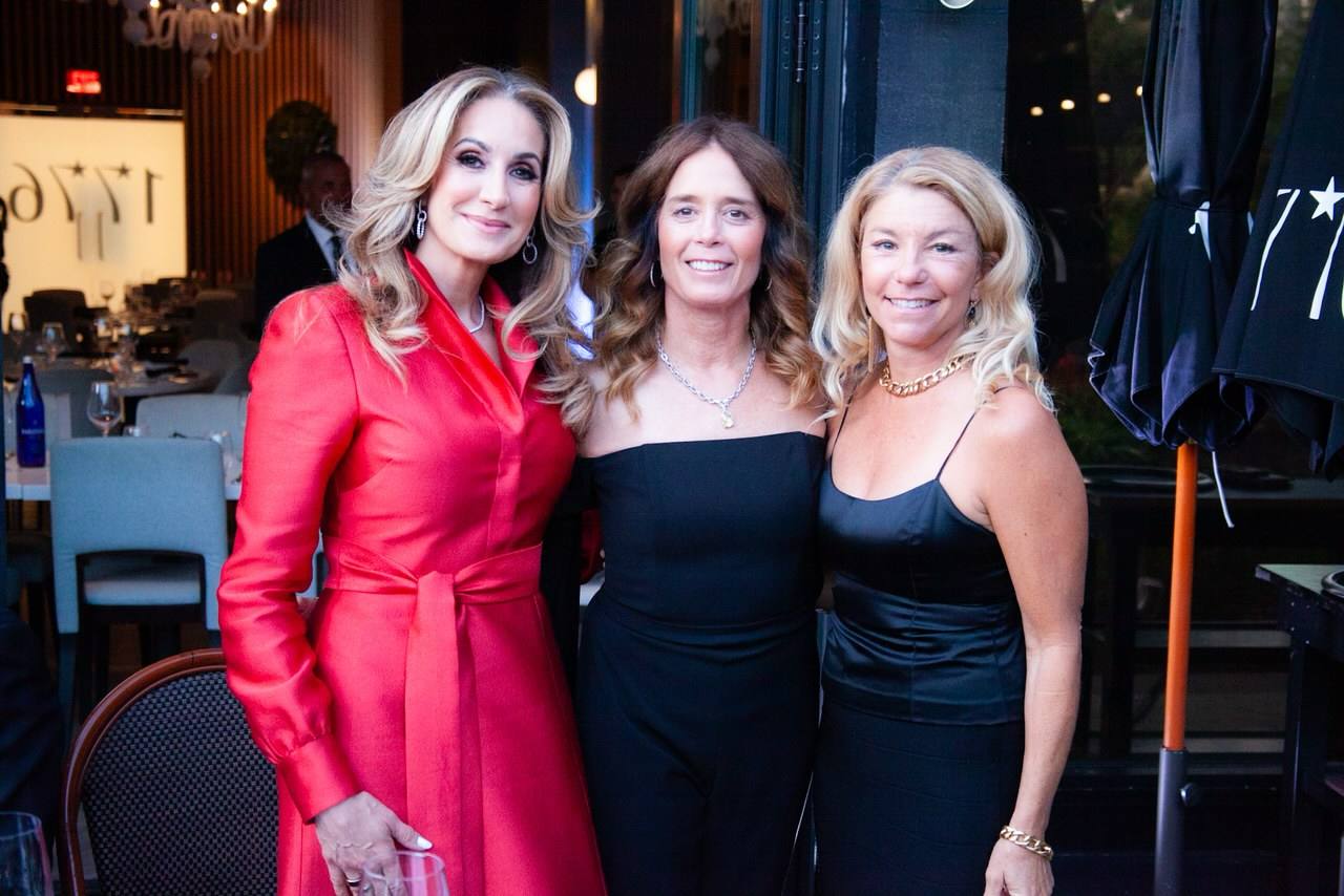 Three ladies dressed in cocktail attire at the 1776 New Years Event