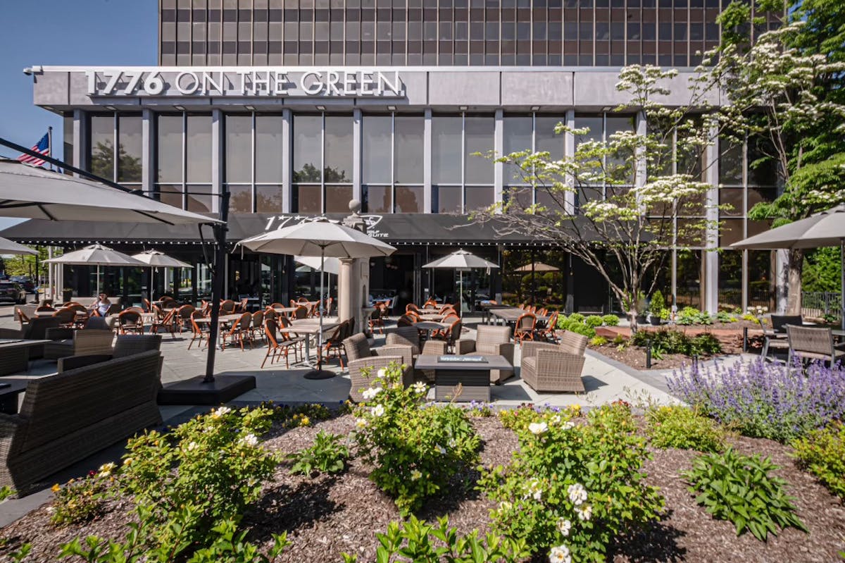 A hotel patio filled with colorful flowers, creating a vibrant and inviting outdoor space for guests to enjoy.