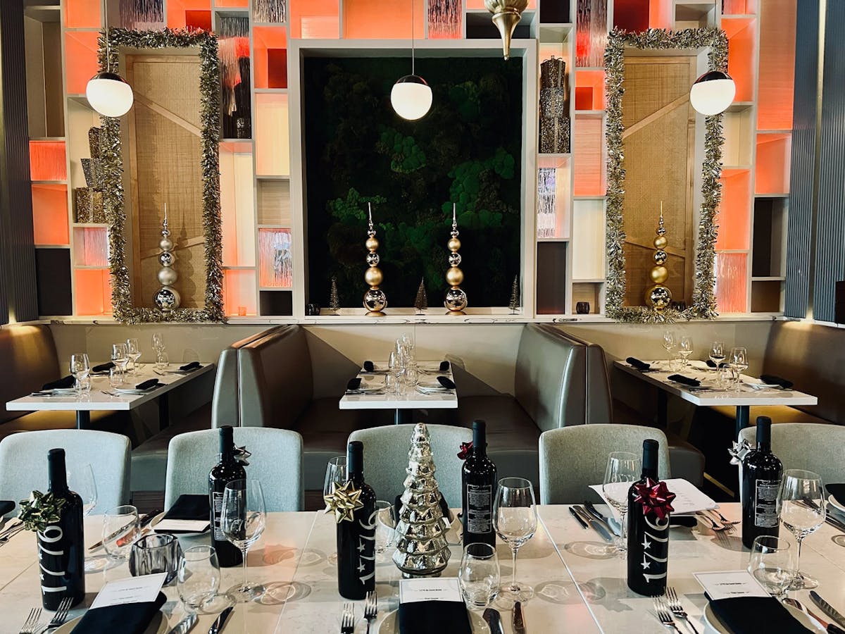 A sophisticated restaurant featuring elegant white tablecloths and polished silverware, creating a refined dining atmosphere.