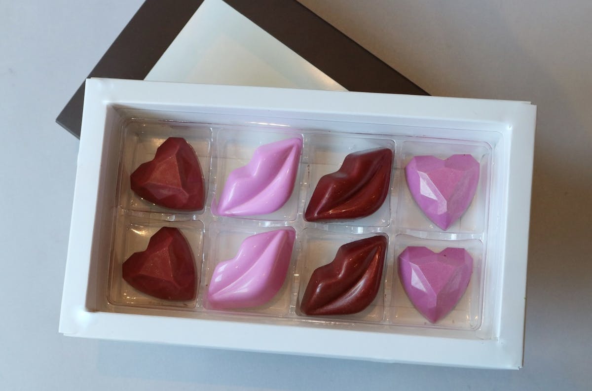 a pink box filled with different types of food on a tray