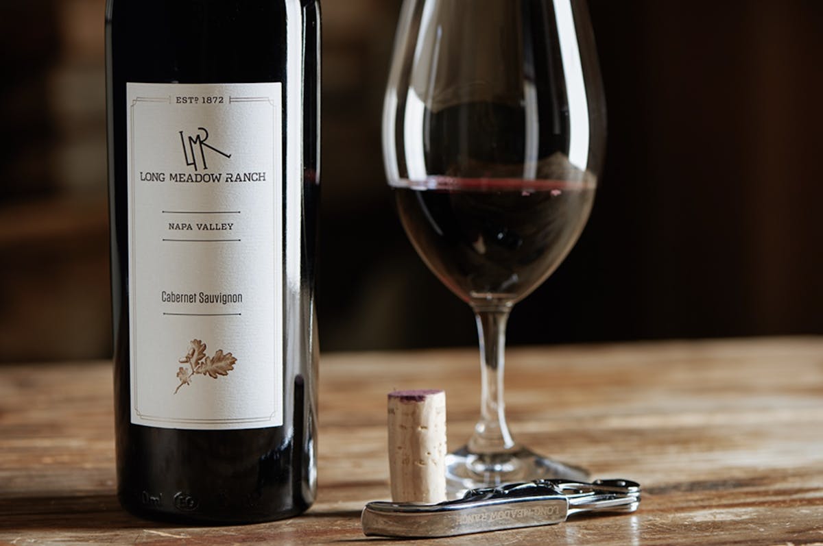 a close up of a bottle and a glass of wine
