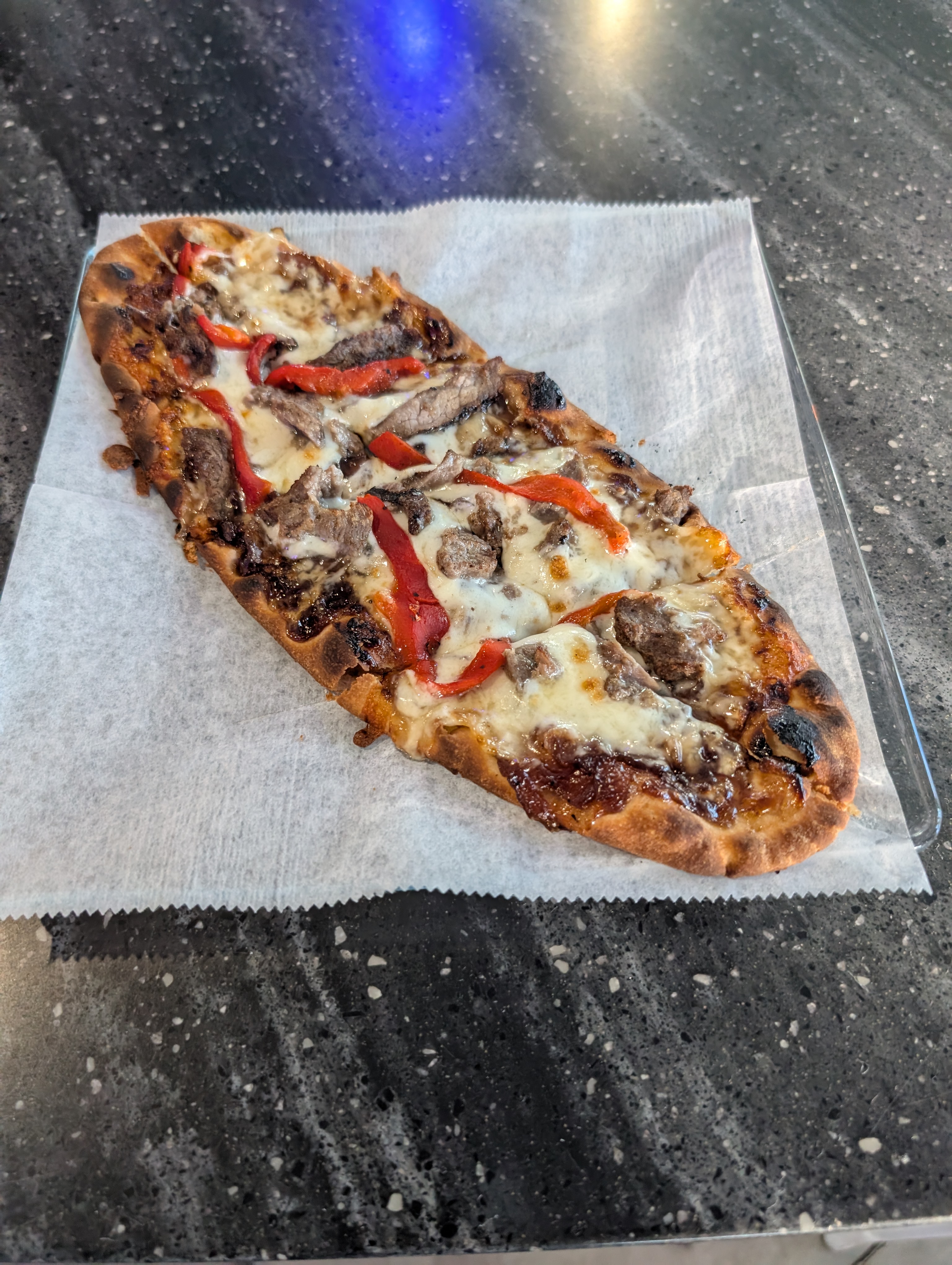 a slice of pizza sitting on top of a table
