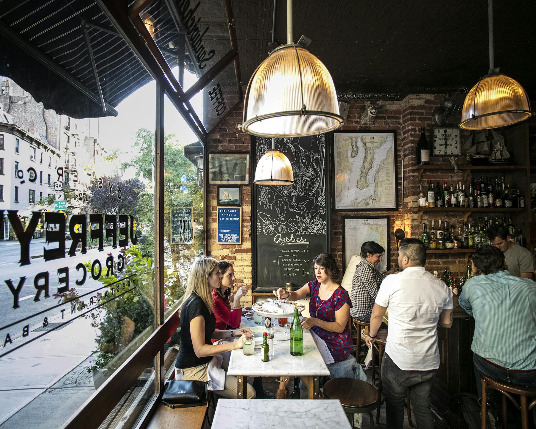 a group of people sitting at a table in front of a building