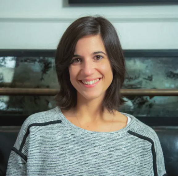 a woman standing in front of a window