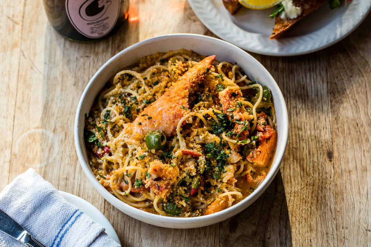 a bowl of food sitting on top of a wooden table