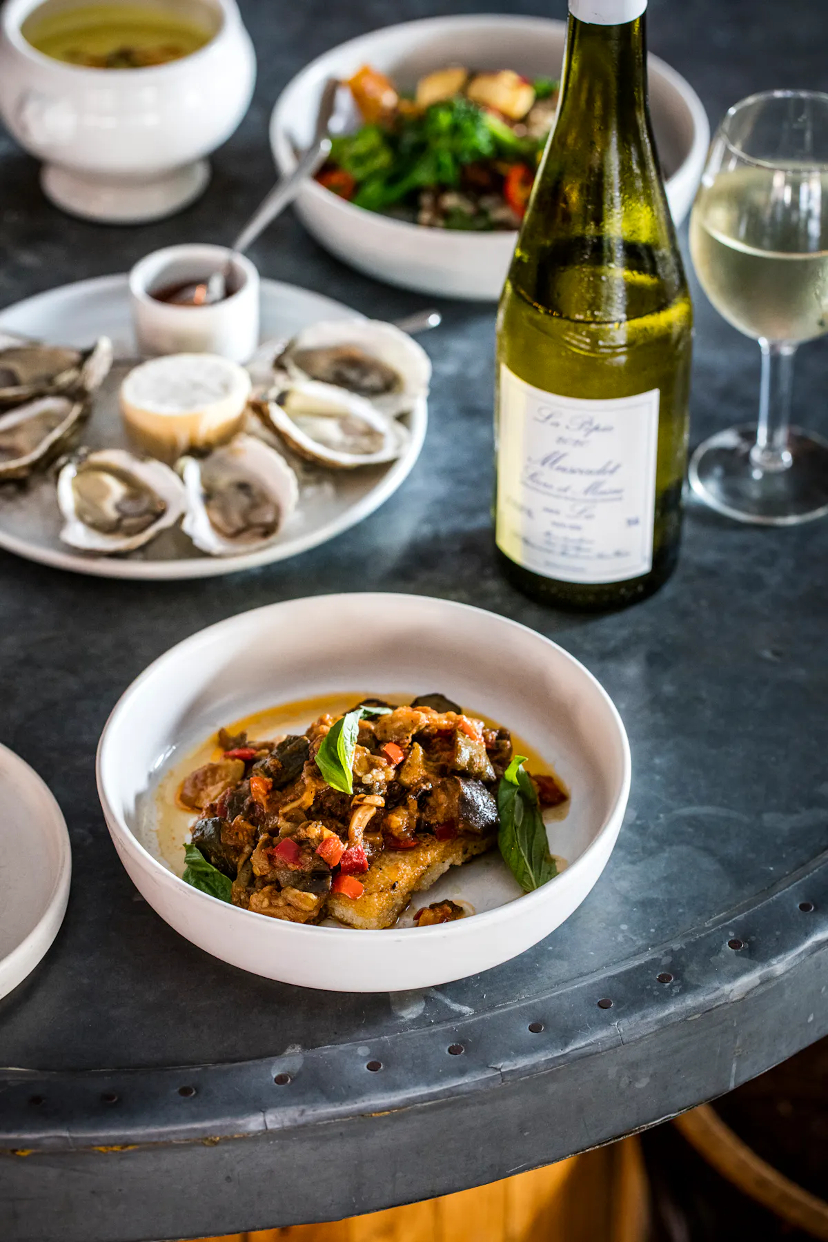 a plate of food and glasses of wine