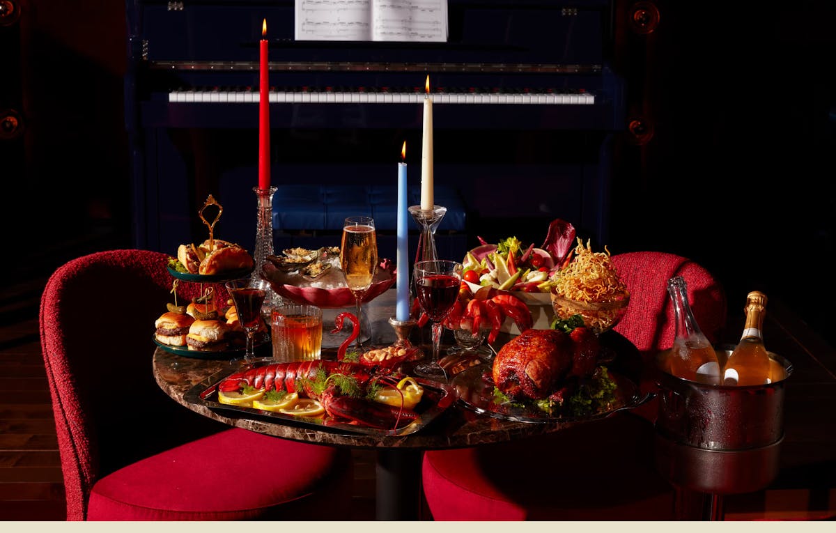 a vase of flowers on a table with food around it
