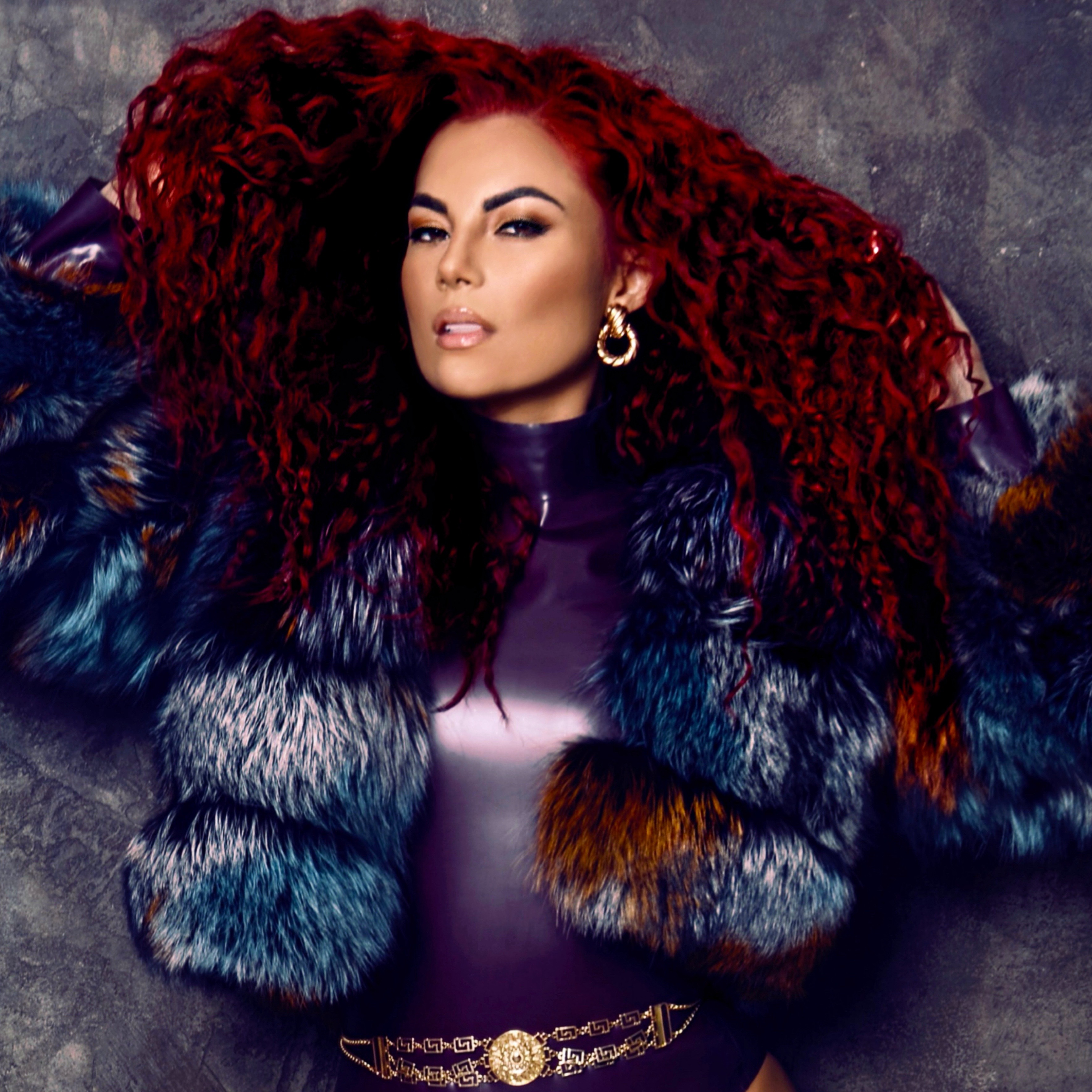 a woman with red hair wearing a fur coat
