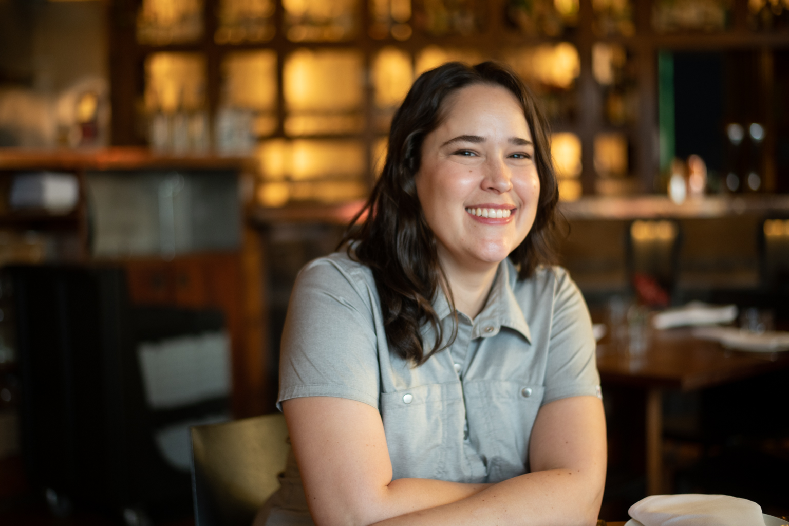 a woman sitting at a table in a restaurant