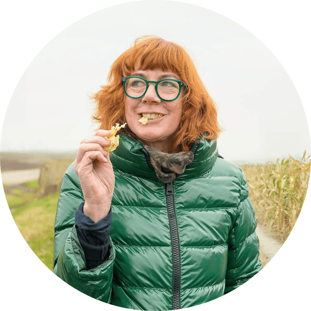 a woman standing in front of a mirror posing for the camera