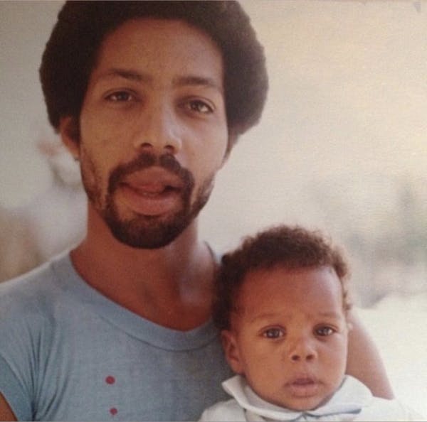 a man and a baby looking at the camera