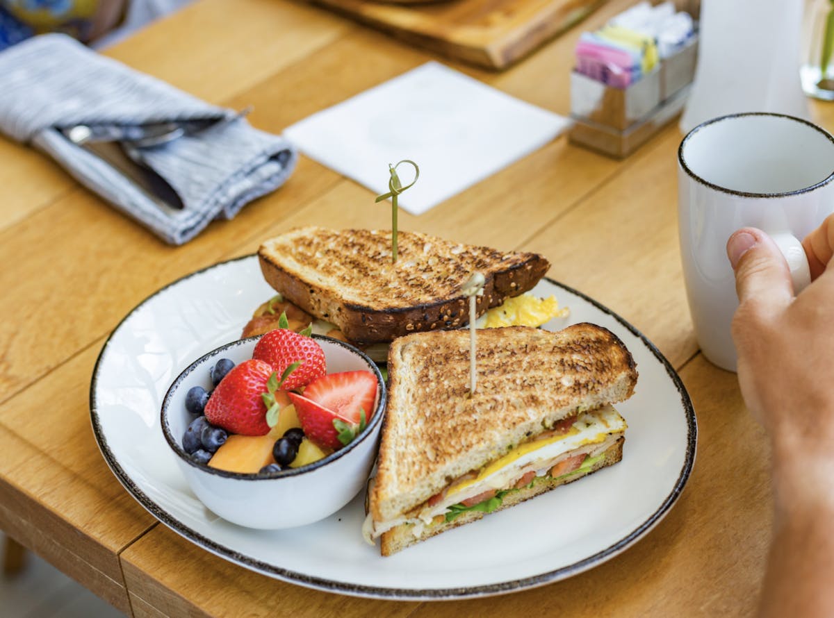 a plate of food with a slice of cake on a table