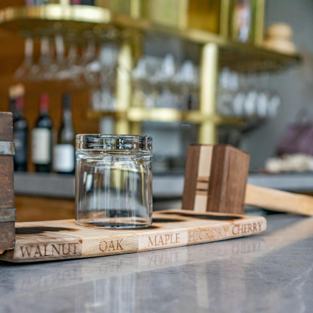 a close up of a glass vase sitting on top of a wooden table