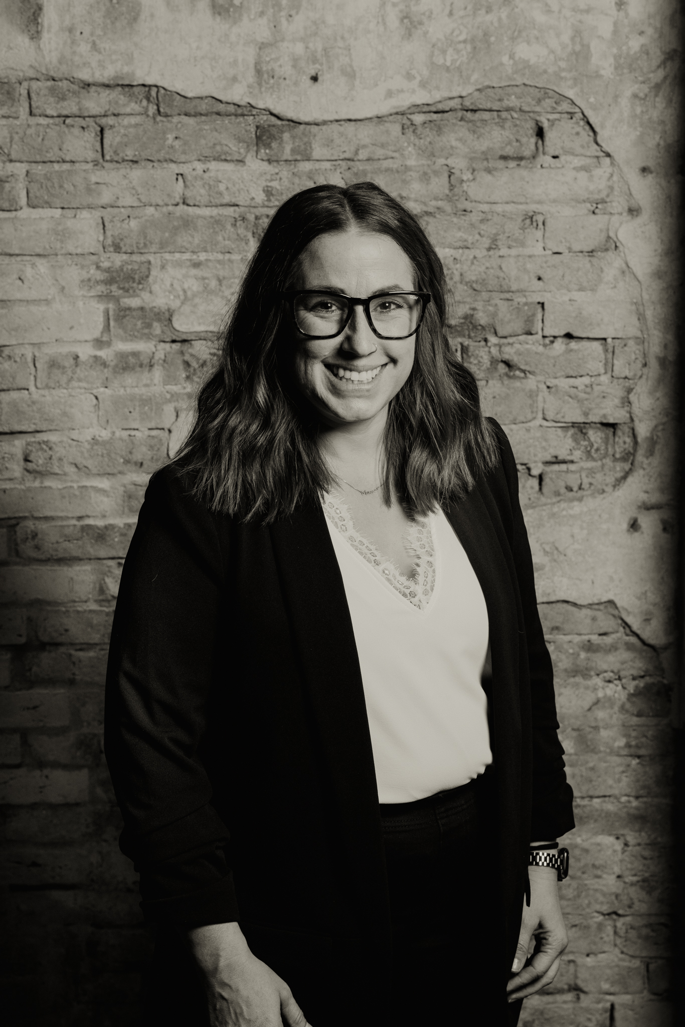 a person standing in front of a brick wall