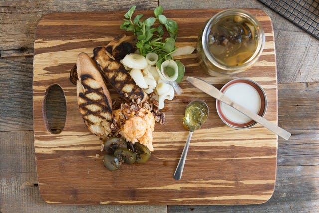 a bunch of food on a wooden cutting board